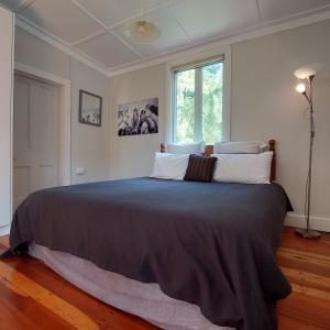 een groot bed in een slaapkamer met een raam bij Morere cottage in Morere