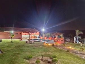 - une cour de nuit avec une piscine dans l'établissement Pesqueiro & Chácara Moenda, à Itapetininga