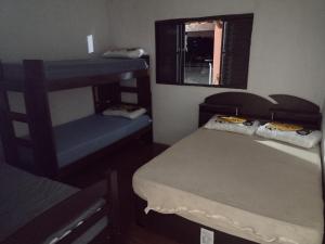 Cette chambre comprend 2 lits superposés et une fenêtre. dans l'établissement Pesqueiro & Chácara Moenda, à Itapetininga