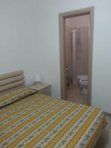 Postel nebo postele na pokoji v ubytování Camping Cala dei Ginepri