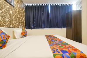 a bedroom with a bed and a window at FabHotel Prithviraj in Indore