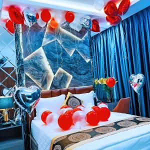 a bed with red and white balloons on it at GRAD Queen Hotel 2 - Hà Đông in Hanoi