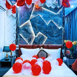 a bed with red and white balloons on it at GRAD Queen Hotel 2 - Hà Đông in Hanoi