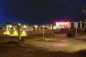 a building with red lights on it at night at Desert Signature Resorts in Sām