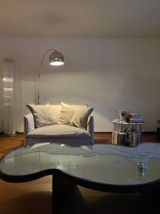 a living room with a couch and a glass table at Chesa Residence in St. Moritz