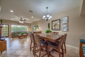 a dining room and living room with a table and chairs at River Zen CW C207 in New Braunfels
