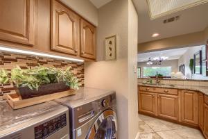 a kitchen with a washer and dryer with plants on the counter at River Zen CW C207 in New Braunfels