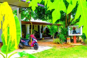 a scooter parked in front of a house at Mahee Villa & Ayurvedic Spa in Dambulla