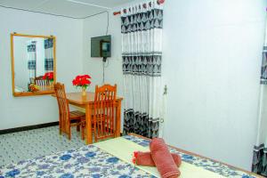 a bedroom with a bed and a table and a mirror at Mahee Villa & Ayurvedic Spa in Dambulla