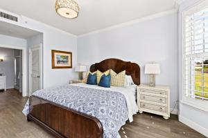 a bedroom with a large bed with blue pillows at Bologna Golf Condo in the Lely Resort in Naples +41 photos