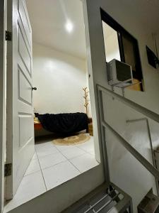 a hallway with a door leading to a bathroom with a mirror at FLATFORM RENTALS (PAWN'S ROOM) in Cebu City