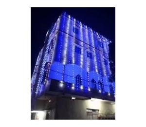a building is lit up with blue lights at Hotel Pratima And Banquet Hall, Muzaffarpur in Muzaffarpur