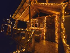 a house with lights on the deck at night at Life on the farm in Nepravishtë