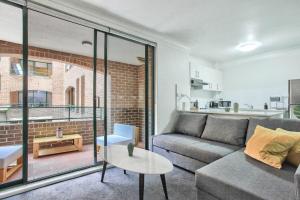 a living room with a couch and a table at Stylish 2 Bedroom Apartment Chippendale in Sydney