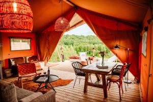 a room with a table and chairs in a tent at Hotel Głęboczek Vine Resort& Spa in Wielki Głęboczek