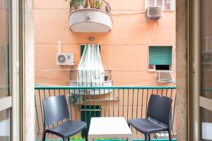 a balcony with chairs and a table and a building at Sweet home Q.S in Naples