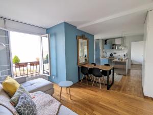 a living room with a couch and a table at Cosy little nest next to Paris in Issy-les-Moulineaux