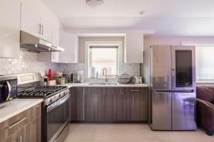 a kitchen with a stainless steel refrigerator and a sink at cozy private room 2 in flushing in Flushing