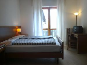 Postel nebo postele na pokoji v ubytování Albergo Miravalle