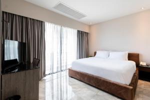 Ліжко або ліжка в номері Sukhothai Hotel and Residence