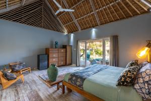 a bedroom with a large bed and a large window at Laguna Biru in Nusa Lembongan +36 photos