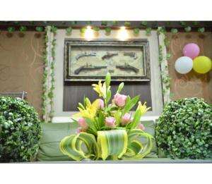 a bouquet of flowers in a vase on a table at Hotel Janvi International Inn, Muzaffarpur in Muzaffarpur