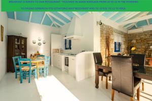 a kitchen with a table and chairs and a dining room at MANI HOLIDAY HOUSE in Kotrónion