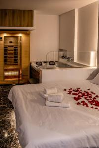 a hotel room with a bed with roses on it at Agia Sofia luxury suite & spa in Thessaloniki