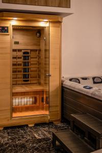 a room with a bed and a wooden closet at Agia Sofia luxury suite & spa in Thessaloniki