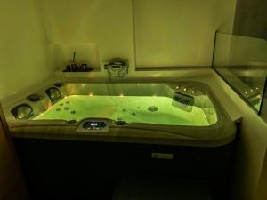 a bathroom with a green bath tub in a room at Agia Sofia luxury suite & spa in Thessaloniki