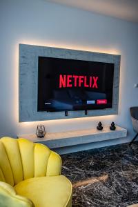 a television with the netflix sign on a wall at Agia Sofia luxury suite & spa in Thessaloniki