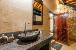 a bathroom with a stone sink on a counter at Senang Villa by Ambassador in Gili Islands +54 photos