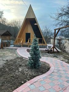 a christmas tree in front of a house at Dilijan Gold Resort in Dilijan