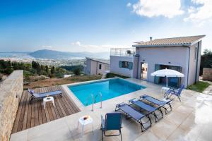 a villa with a swimming pool and a house at Villelia View Villas 1 in Apolpaina