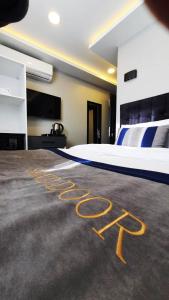 a bedroom with a bed with the word hotel written on the floor at SAND DOOR HOTEL in Istanbul