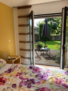 a bedroom with a bed and a sliding glass door at Pension Froschkönig in Forchheim