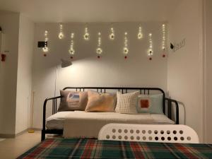 a bedroom with a bed with lights on the wall at J-Stay near Hongdae in Seoul