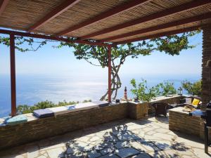 a patio with a view of the ocean at The Stone Lookout Villa in Apróvaton