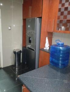a kitchen with a black refrigerator and a counter top at JustV14 in Mahikeng