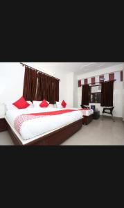 a bedroom with two beds with red pillows at Hotel Best stay haridwar by Shiva Palace in Haridwār