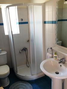 a bathroom with a shower and a toilet and a sink at Angelica Villas Hotel Apartments in Ancient Epidauros +42 photos