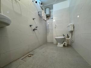 a bathroom with a toilet and a sink at Hotel Nalanda City in Nalanda