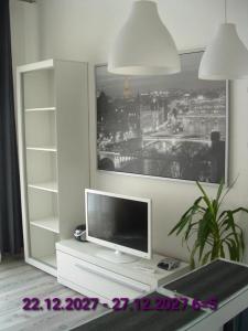 a tv sitting on a table in a living room at Nice Apartments Prague in Prague