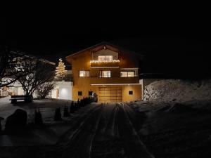 a house in the snow at night at Ladinser Hof Kuschelecke in Castelrotto