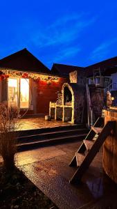 a house with christmas lights on the side of it at Pensiunea Sălaș in Sălaşu de Sus