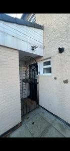 an entrance to a building with an iron gate at Entire 3 bedrooom holiday home in Liverpool