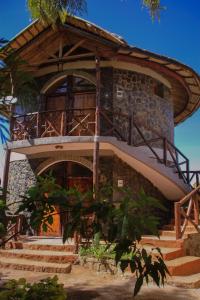 a building with stairs and a balcony on it at Lalibela Hidmo Cozy Place in Lalībela