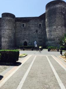 a building with two towers and a person on a bike at Appartamento Giada in Catania