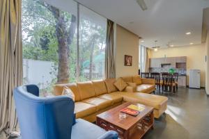 a living room with a couch and a table at Eternal wave by HappyInch in Calangute