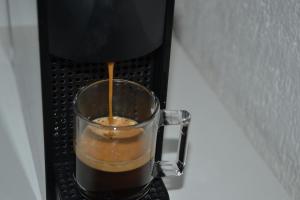 a drink is being poured into a mug at Chalet Mont Blanc de Courmayeur in Courmayeur
